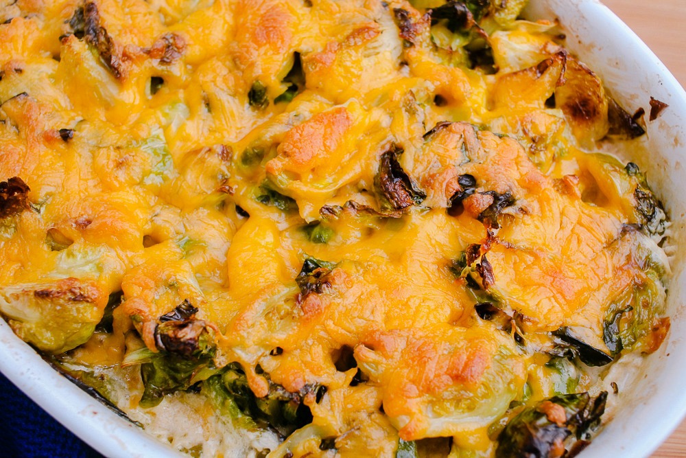roasted brussels sprouts with melted cheese in baking dish