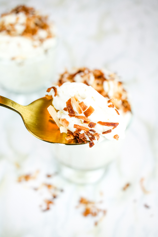 a gold spoon with toasted coconut low carb mousse