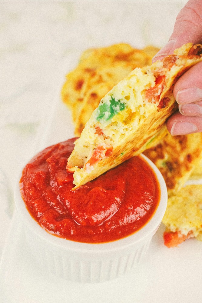 a piece of pizza pancake dipped in pizza sauce