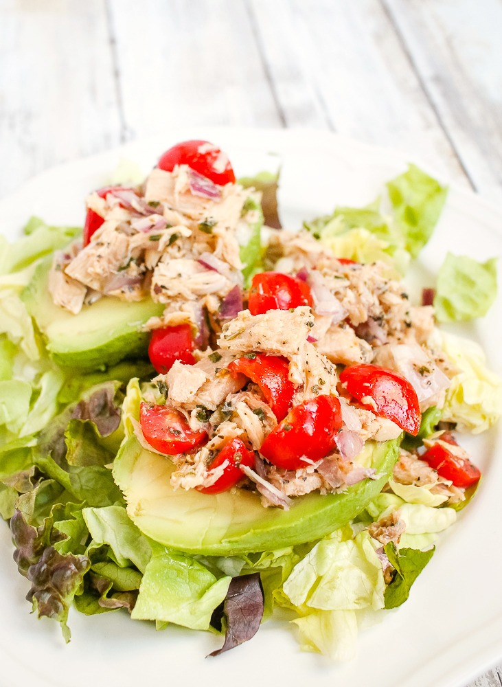 plate with greens, avocado halves and Mediterranean Tuna Salad