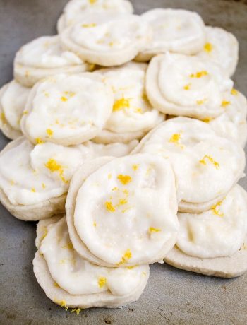 a pile of lemon shortbread cookies with lemon zest frosting