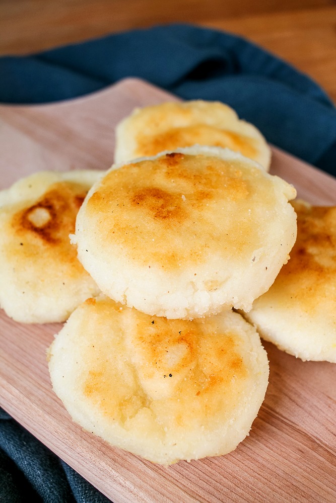 a pile of Venezuelan arepas on a cutting board
