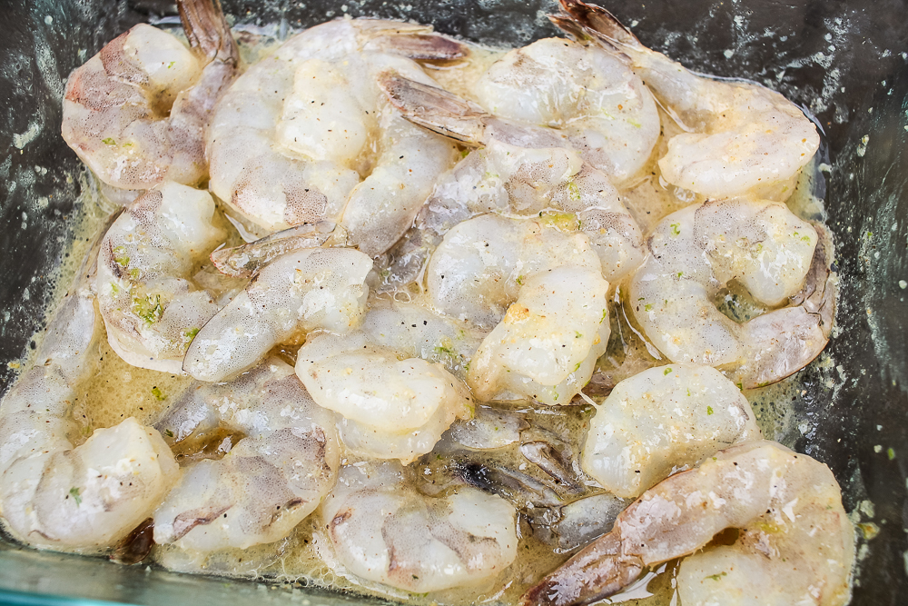 raw shrimp marinating in a honey lime dressing
