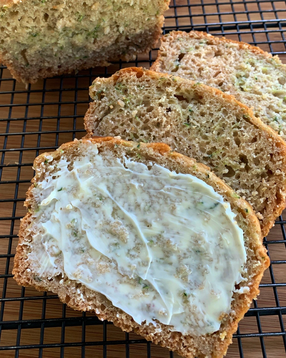 slices of healthy zucchini bread spread with butter
