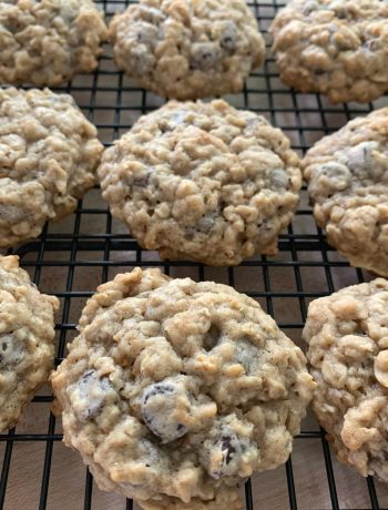 a black cooling rack with rows of banana oatmeal chocolate chip cookies