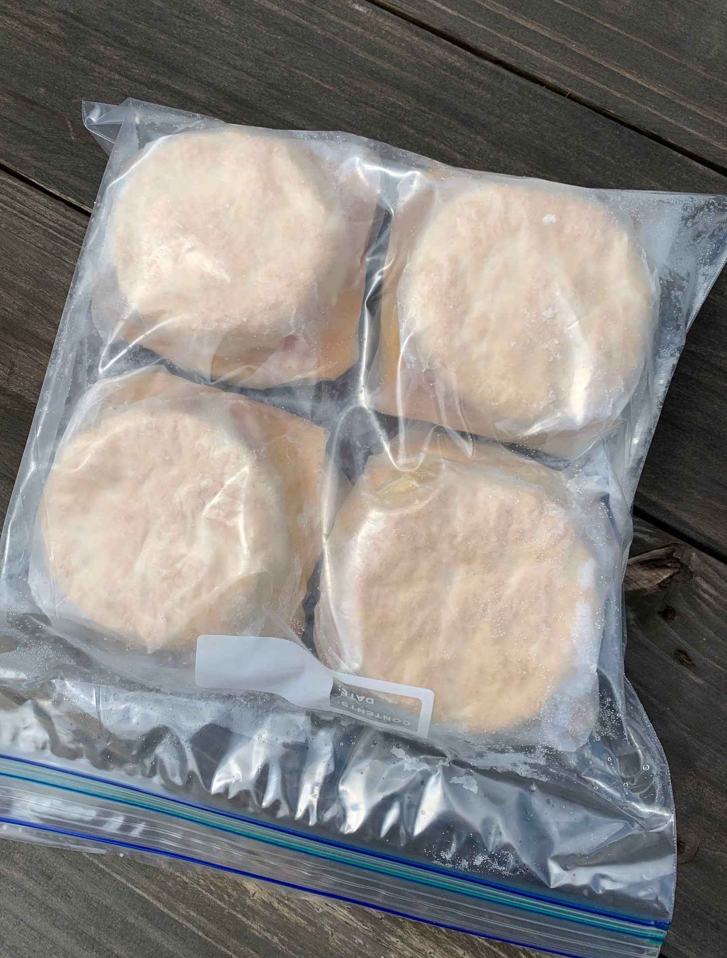 a baggie with 4 individually wrapped bacon, egg and cheese biscuit sandwiches