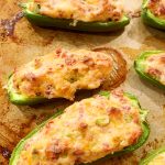 bacon jalapeno poppers cooked on a baking sheet
