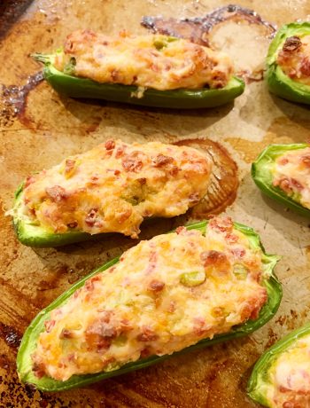 bacon jalapeno poppers cooked on a baking sheet