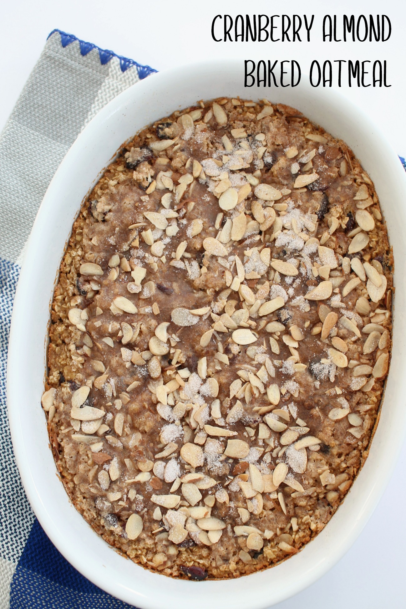 white oval casserole dish with cranberry almond baked oatmeal
