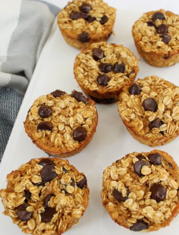 white rectangle plate with 7 peanut butter chocolate chip baked oatmeal muffins