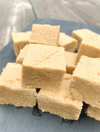 squares of peanut butter fudge up close on a piece of slate