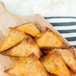 cutting board with cooked pizza wontons