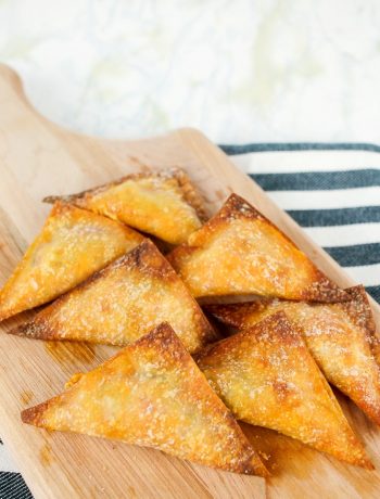 cutting board with cooked pizza wontons