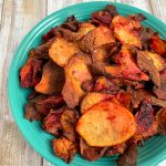 turquoise bowl filled with air fryer potato chips