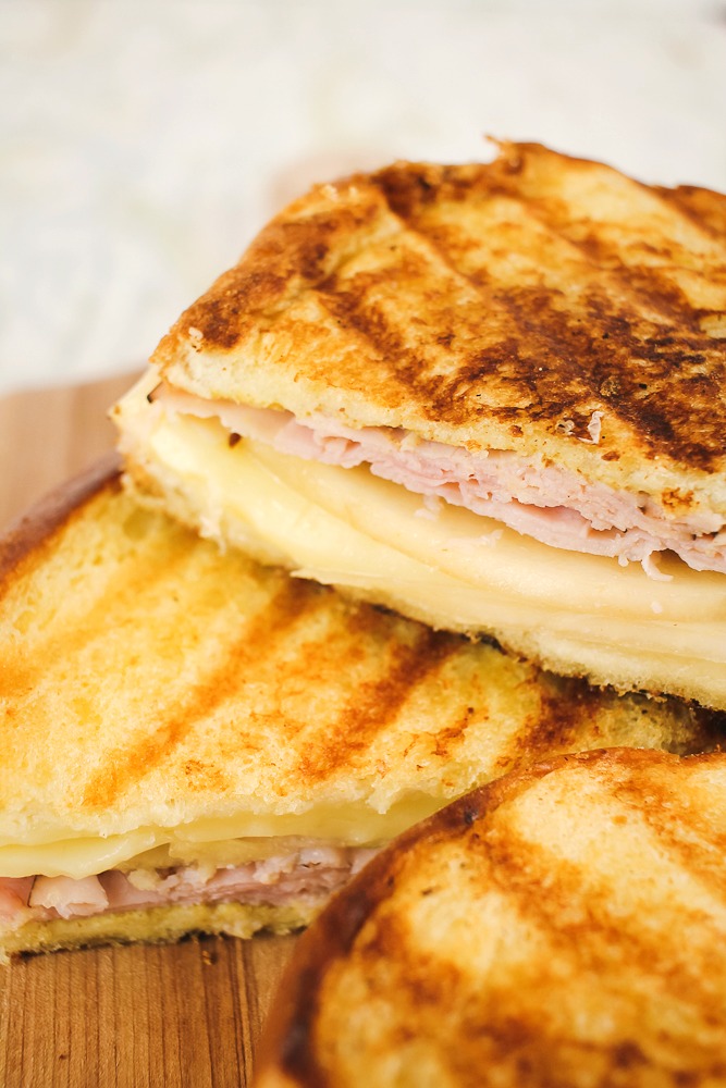 upclose shot of half of a grilled ham, pear and cheese sandwich