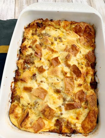 a white 13x9 pan with baked sausage strata