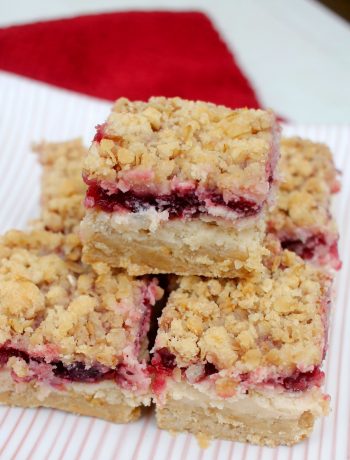 squares of Cranberry Cheese Bars piled on top of each other