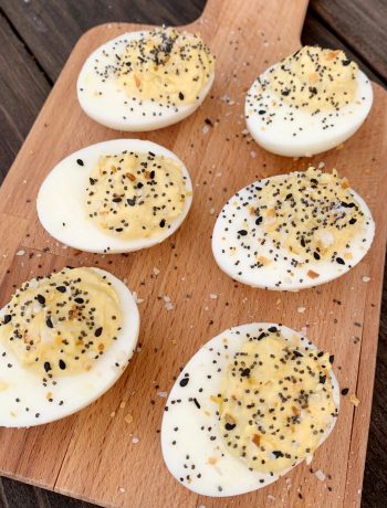 6 Everything But the Bagel Deviled Eggs on a wooden cutting board