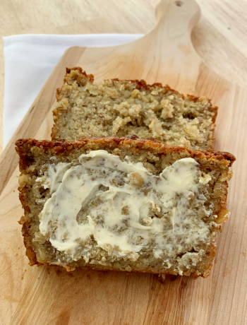 two slices of banana oatmeal bread with the top one buttered