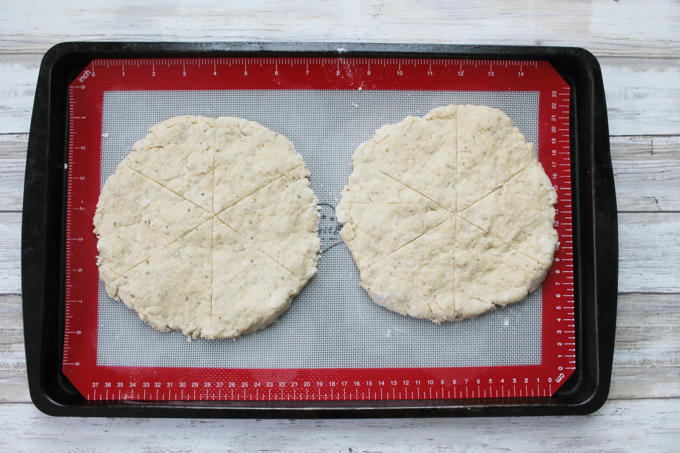 two rounds of scone dough on a cookie sheet