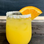 Orange Margarita with a sugar rim and wedge of orange